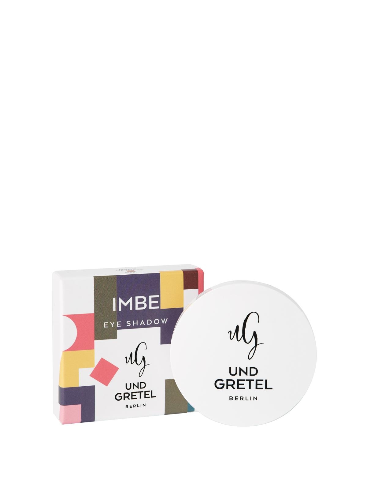 image_121774_2 Und Gretel IMBE Lidschatten in weißer Verpackung mit bunter Schachtel im Hintergrund.