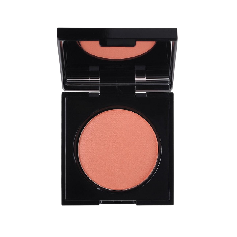 KORRES Wild Rose Rouge in Pfirsichfarbe in einer schwarzen, offenen Puderdose.