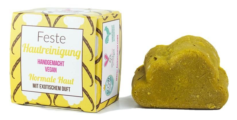 image_119388_1 Handgemachte vegane feste Hautreinigung für normale Haut mit exotischem Duft, Verpackung und Seifenstück nebeneinander.